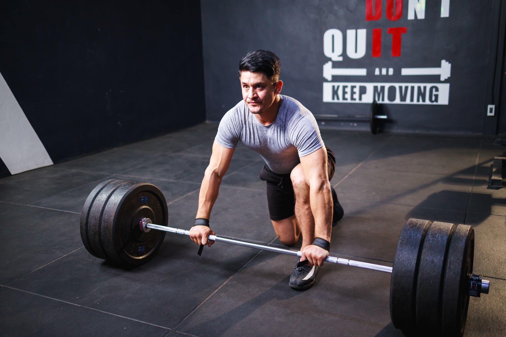 Young strong man doing deadlift exercise in gym. muscles workout bodybuilding concept